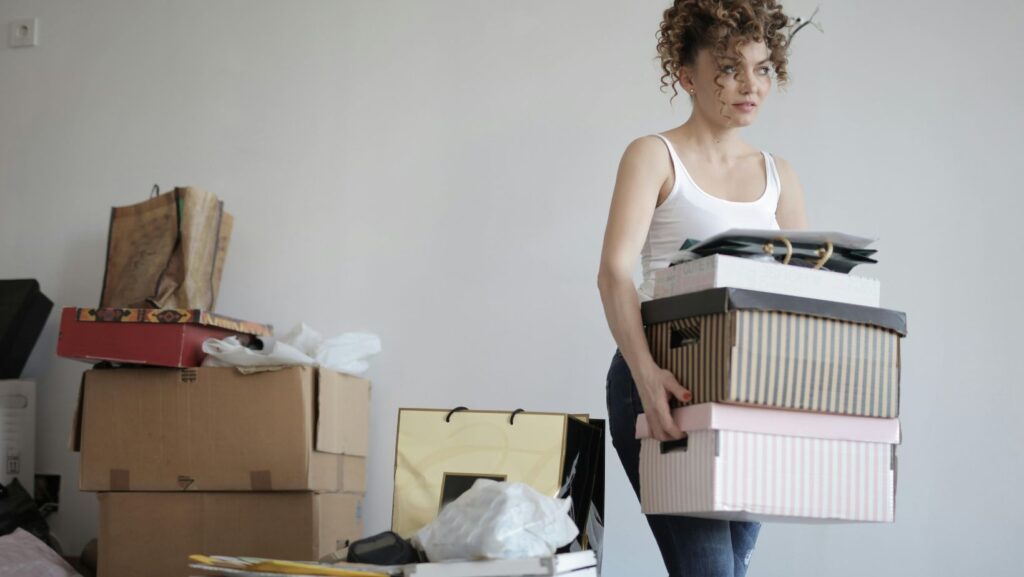 A person carrying boxes in a room