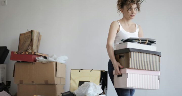 A person carrying boxes in a room