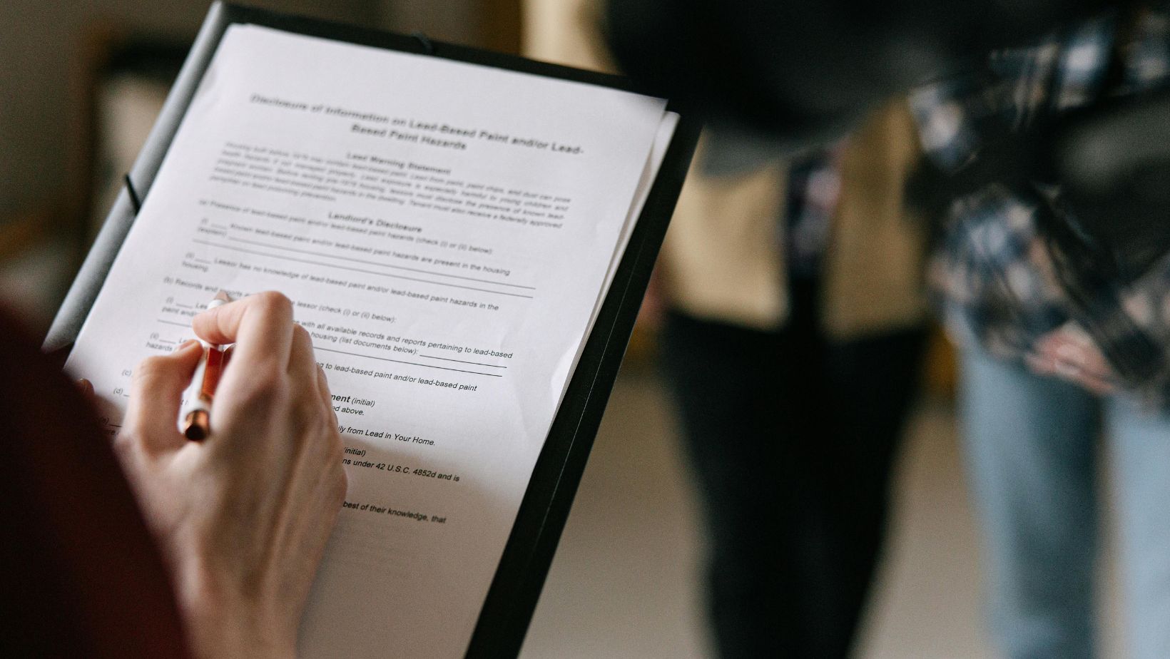 A person holding a pen and paper